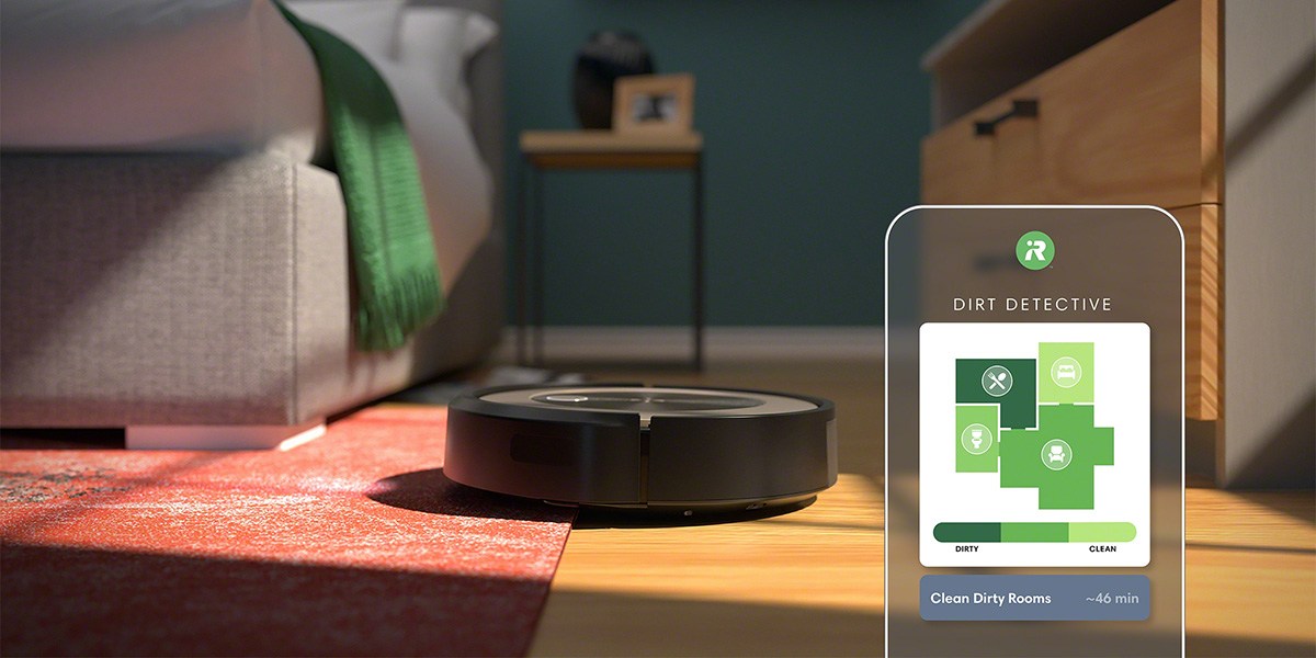 Roomba j9+ sitting half on area rug and half on hard floor with app image in front