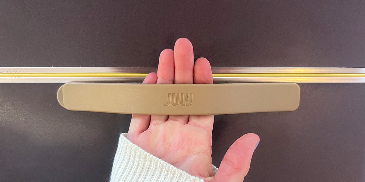 Hand  holding July Checked Trunk  top strap  Hand  holding July Checked Trunk  top strap