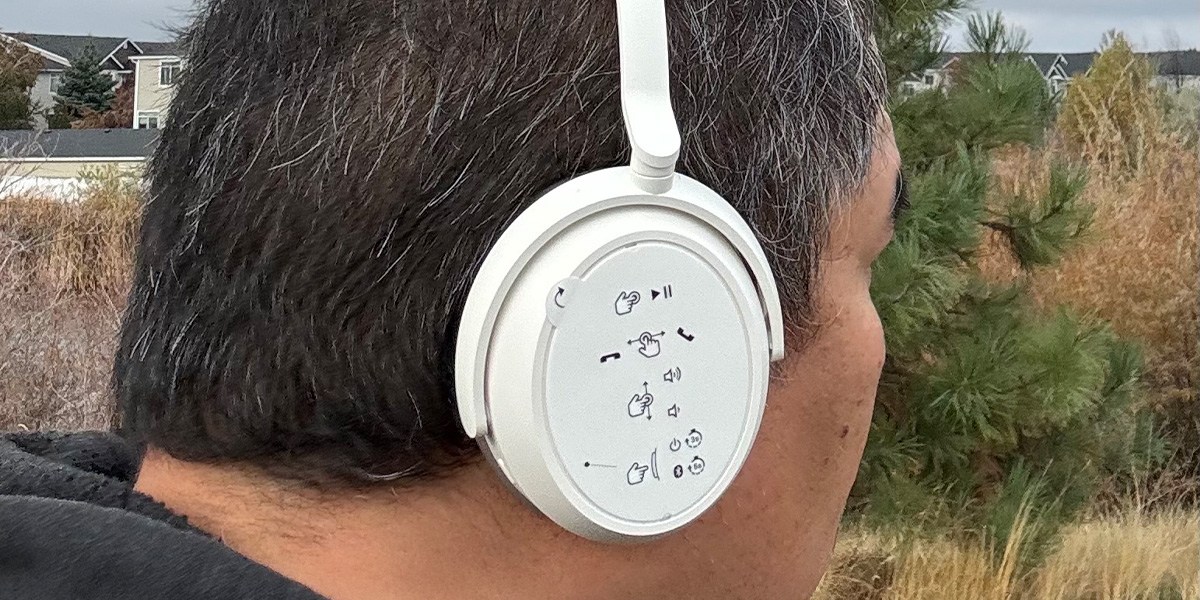 Side view of person wearing white headphones