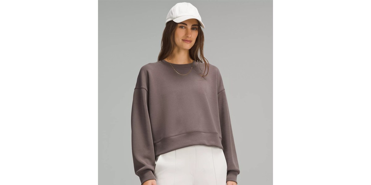 Woman wearing brown cropped crew neck sweatshirt Woman wearing brown cropped crew neck sweatshirt