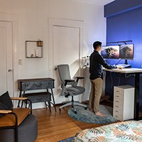 a person standing in front of two monitors