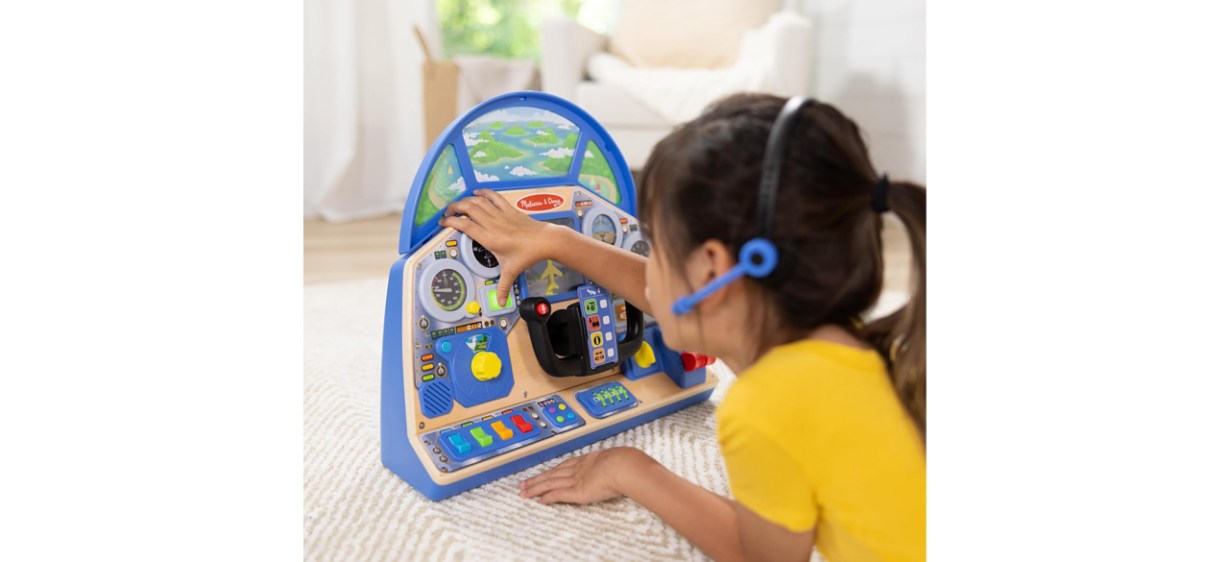 Little girl playing with Melissa &amp; Doug Pilot Dashboard