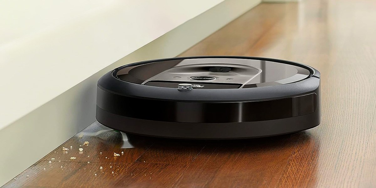 Roomba cleaning hardwood flooring next to wall