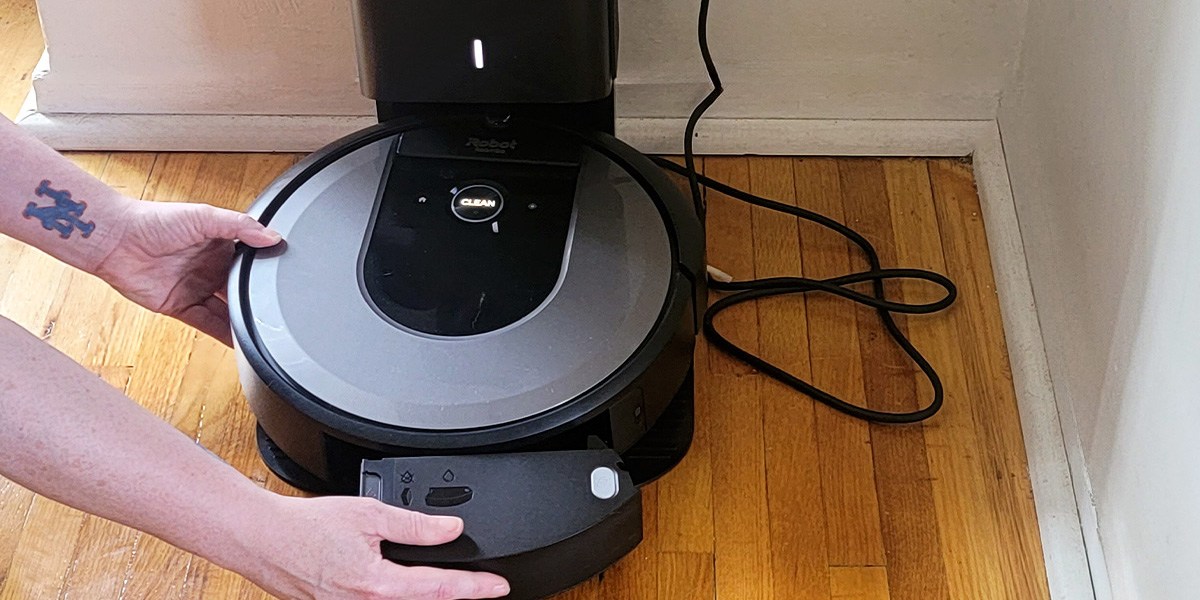 Person removing Roomba's dustbin