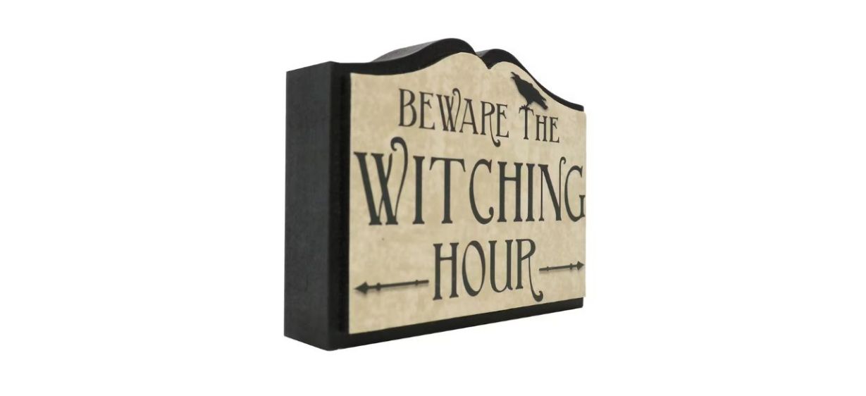 a black and beige tabletop sign that says &quot;Beware the Witching Hour&quot;