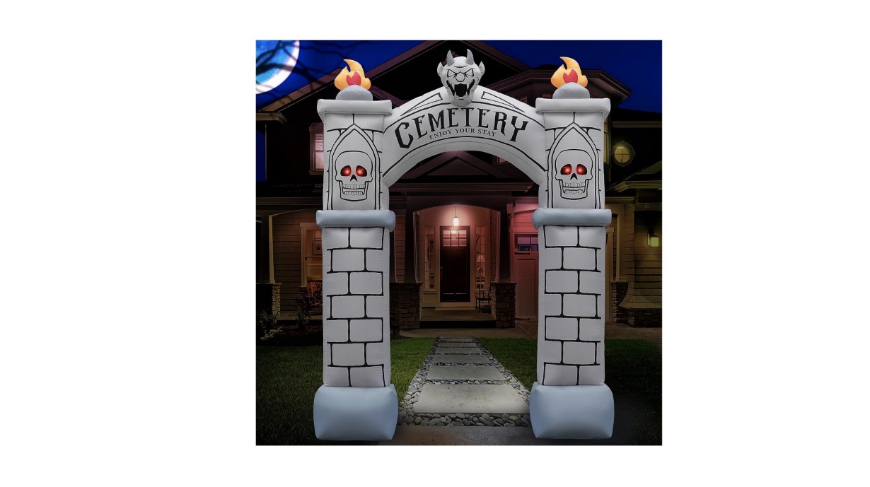 An inflatable archway that looks like it is made of bricks and has the word &quot;cemetery&quot; on it