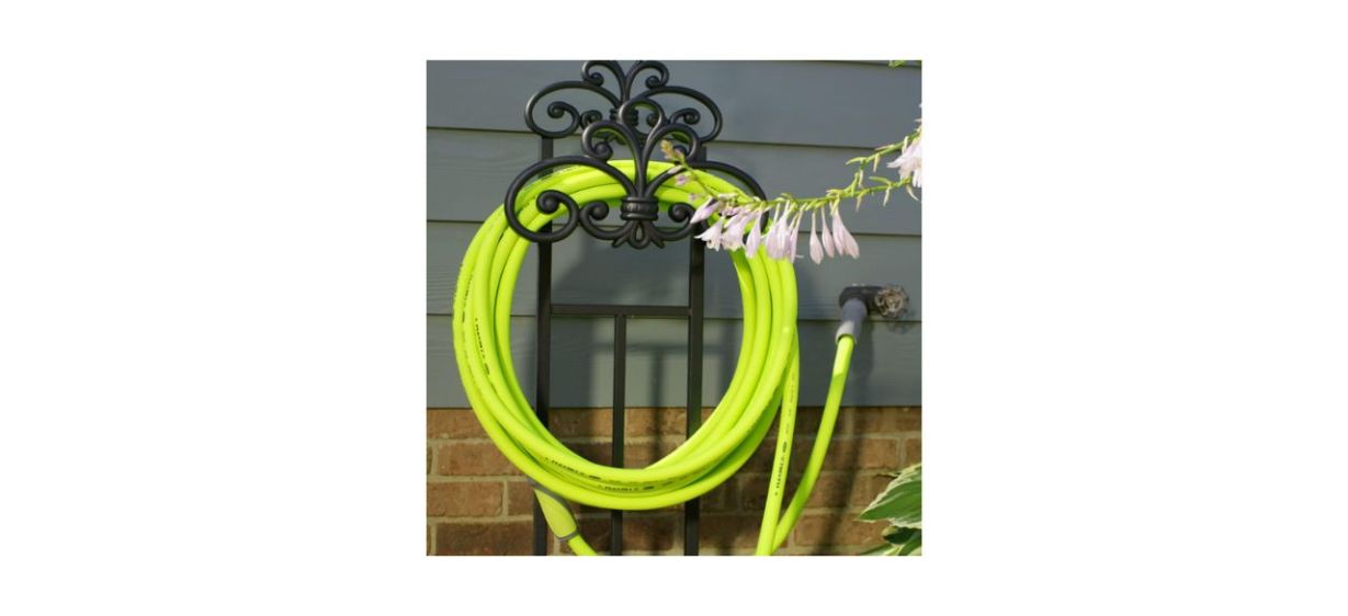 green garden hose hanging on the side of a house
