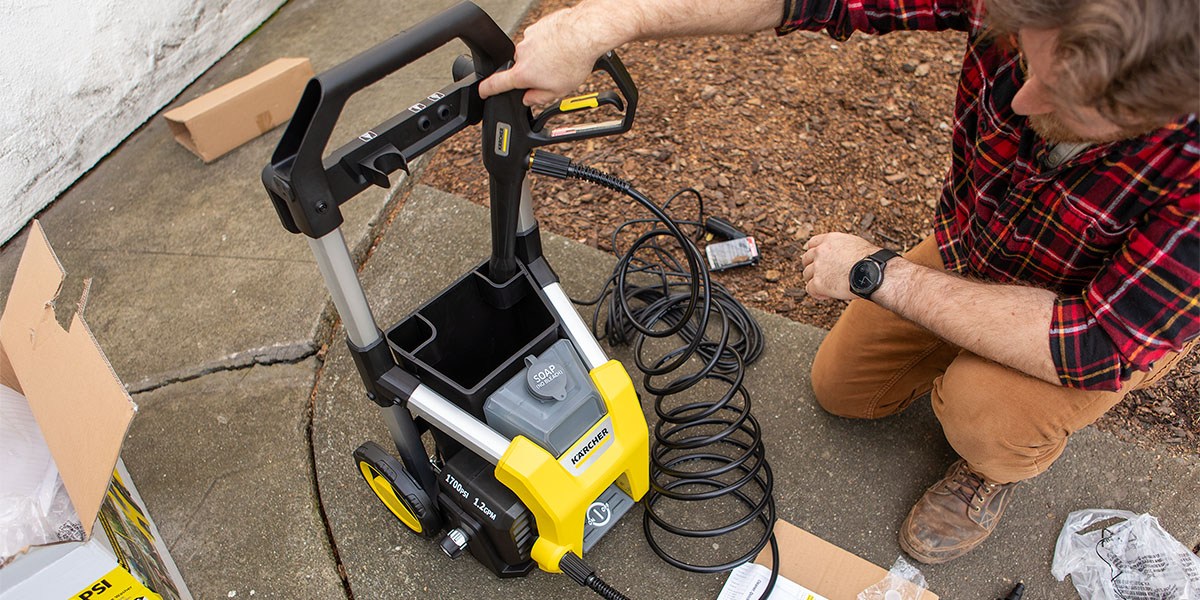 Kärcher K1700 on pavement with person placing wand into holding area